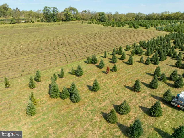 an aerial view of ocean and residential houses with outdoor space