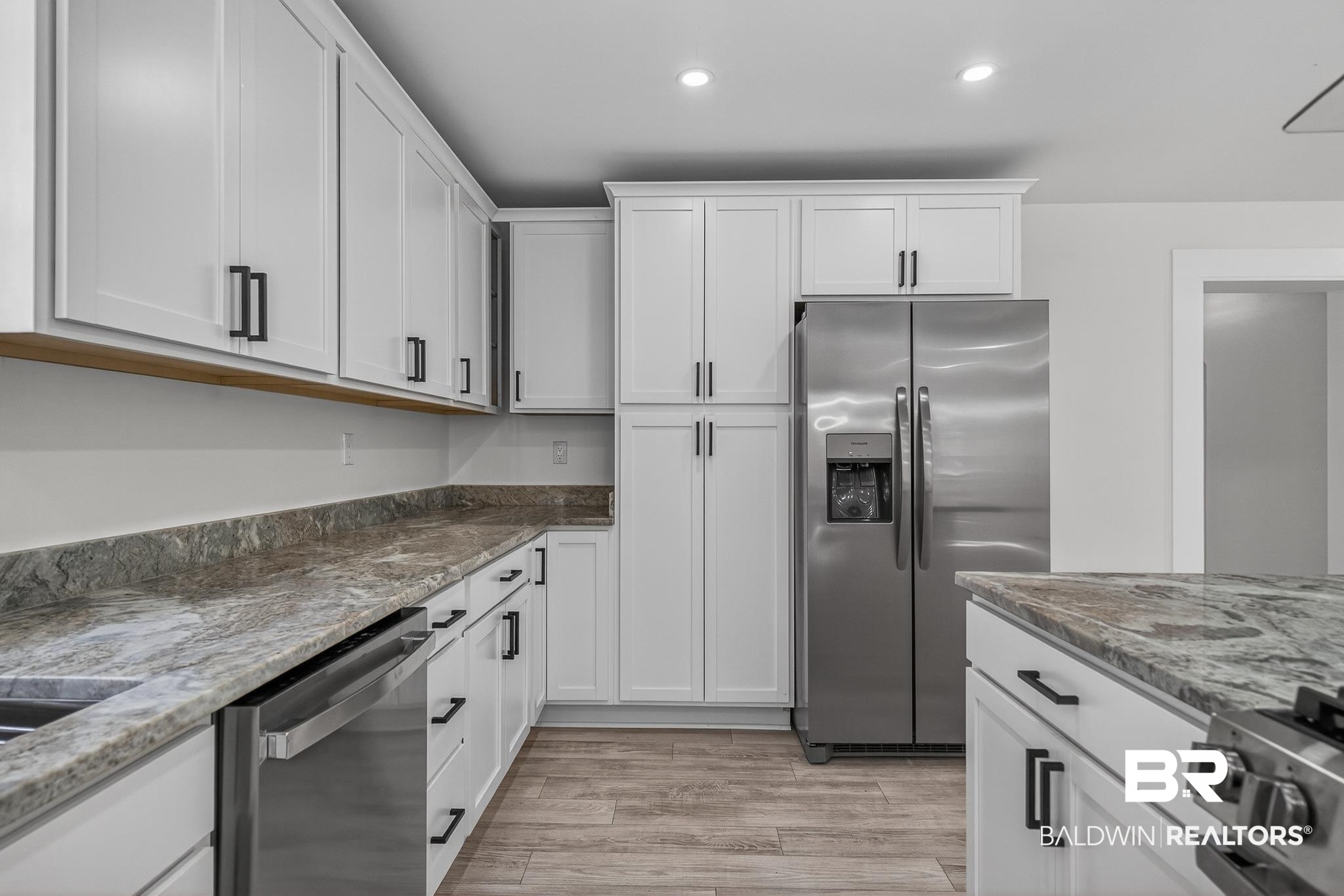 10650 Old Pascagoula Road Theodore, AL 36582 - Photo 23 of 77 Kitchen with white cabinetry, stainless steel appliances, dark stone counters, light wood finished floors, and recessed lighting