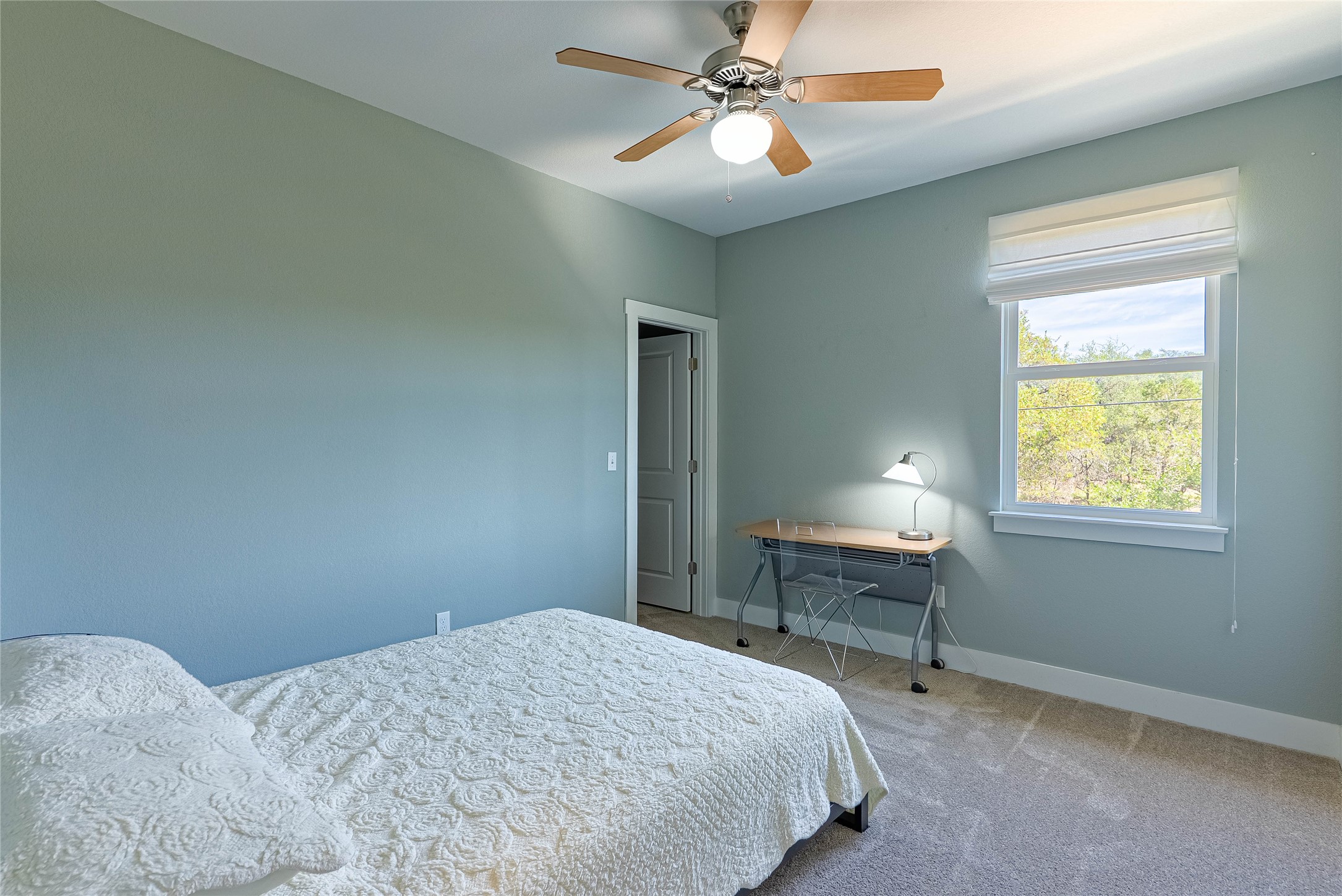 410 Summit Ridge Drive North Point Venture, TX 78645 - Photo 19 of 37 a bedroom with a bed and a table in it
