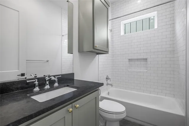 a bathroom with a sink a toilet and bathtub