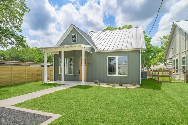 a front view of a house with a yard and porch