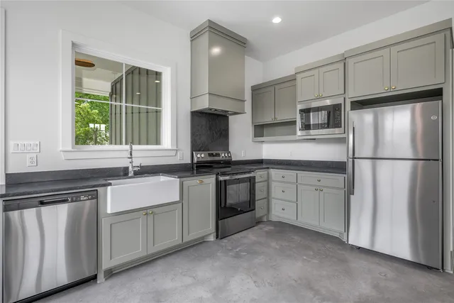 a kitchen with white cabinets and white appliances