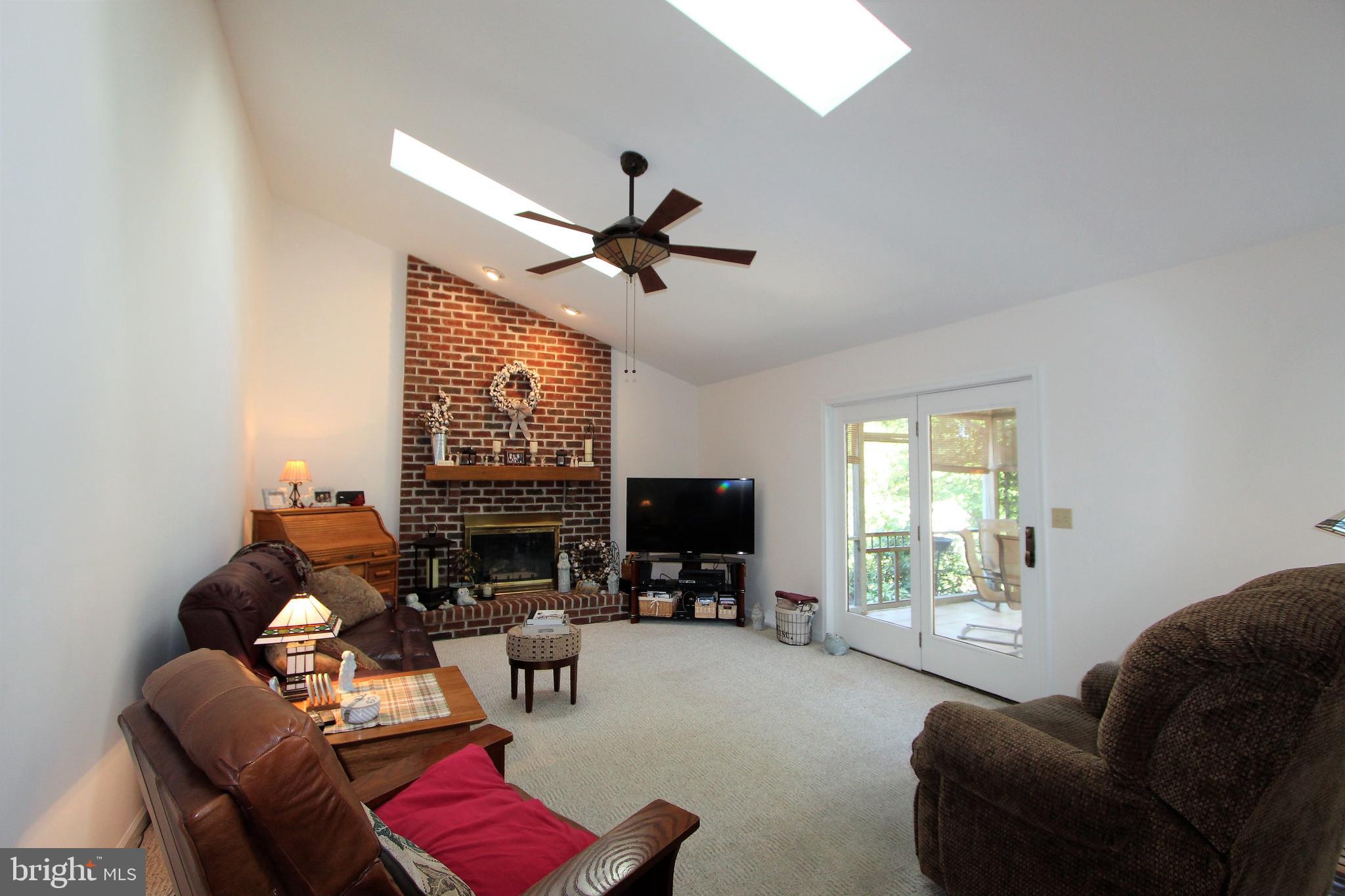 14 Countryside Lane Lititz, PA 17543 - Photo 22 of 41 a living room with furniture a ceiling fan and a flat screen tv