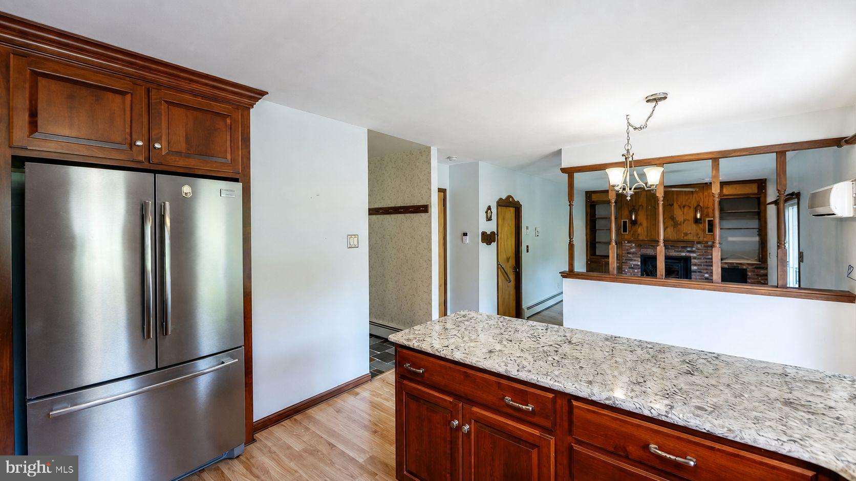 223 Trythall Road Elverson, PA 19520 - Photo 26 of 78 a kitchen with stainless steel appliances granite countertop a refrigerator a oven and a sink with wooden floor