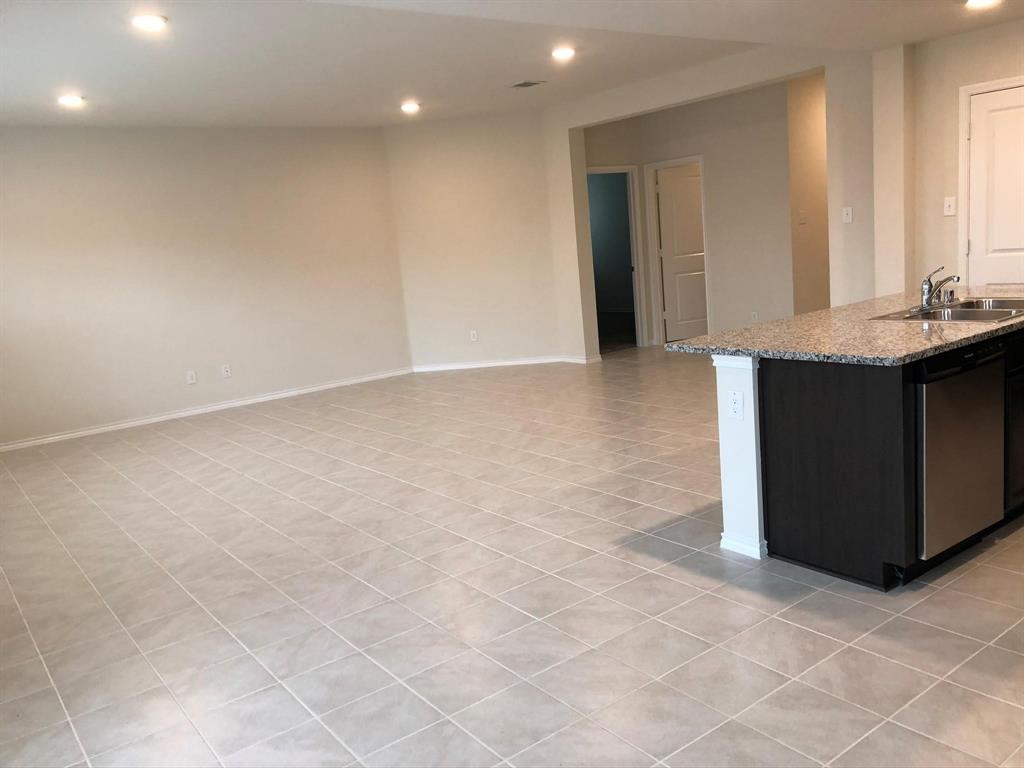 604 Rustic Meadows Trail Princeton, TX 75407 - Photo 3 of 15 an empty room with kitchen and window
