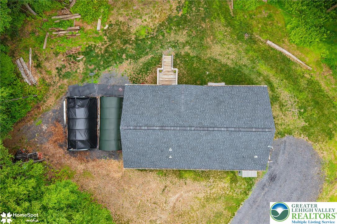 318 Church Road Kunkletown, PA 18058 - Photo 50 of 51 An aerial perspective reveals a charming dwelling nestled amidst lush green surroundings, featuring a robust shingle roof.