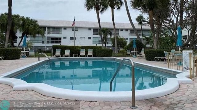a view of a swimming pool with a patio