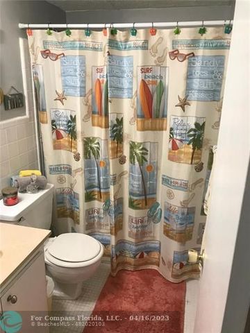 a bathroom with a toilet and shower