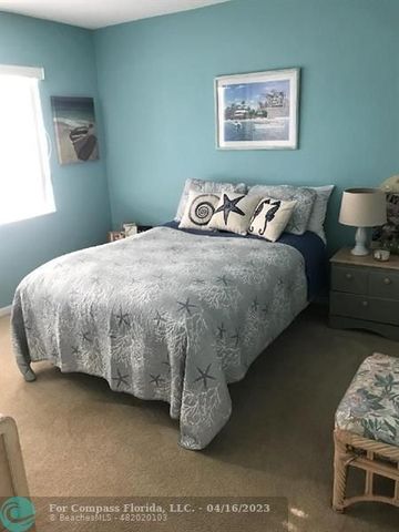 a bedroom with a bed and painting on the wall