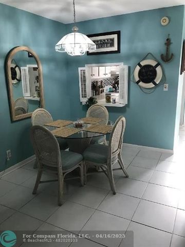 a dining room with furniture and chandelier