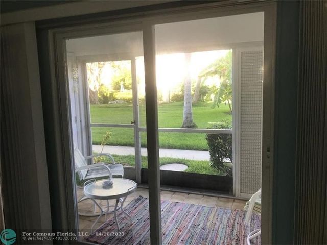 a view of a room with a bed and wooden floor