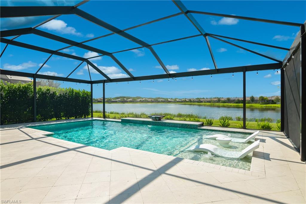 a view of a backyard with table and chairs under an umbrella