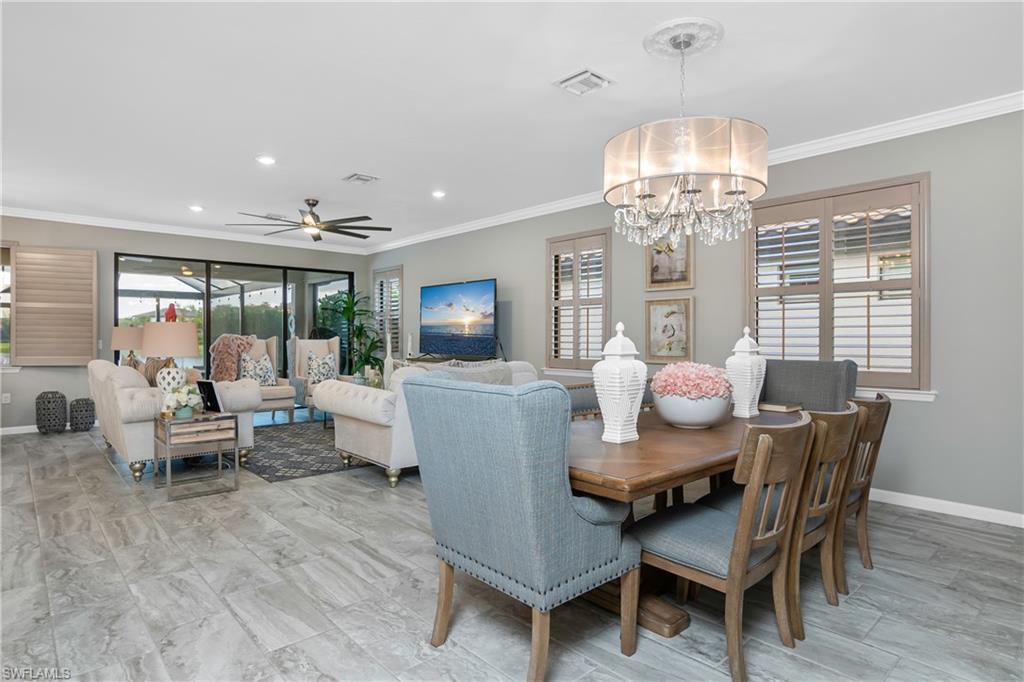 19826 Bittersweet Lane Estero, FL 33928 - Photo 13 of 50 a view of a dining room with furniture a chandelier and wooden floor