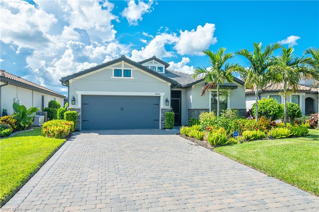 19826 Bittersweet Lane Estero, FL 33928 - Photo 2 of 50 a front view of a house with a yard and potted plants