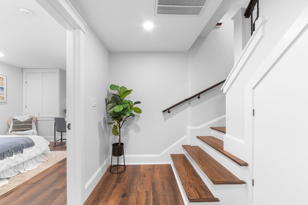 615 East 3rd Street, Unit 1 Boston, MA 02127 - Photo 26 of 42 a view of a hallway with wooden floor and staircase