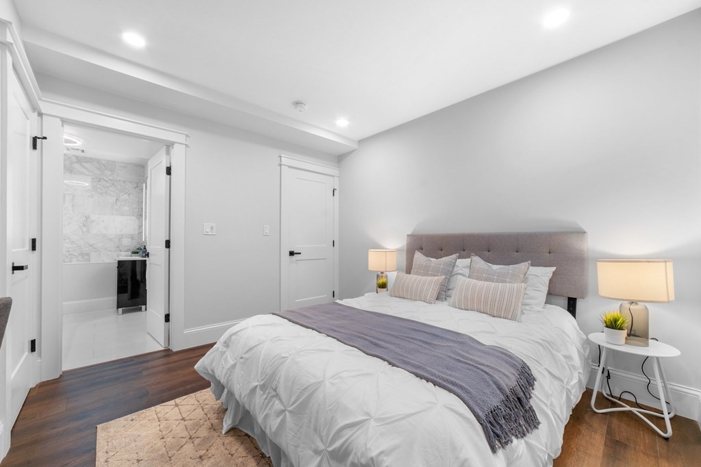 615 East 3rd Street, Unit 1 Boston, MA 02127 - Photo 29 of 42 a bedroom with a bed and a table in it