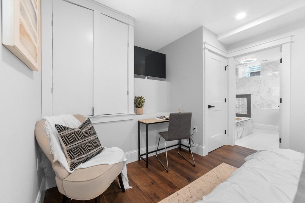 615 East 3rd Street, Unit 1 Boston, MA 02127 - Photo 30 of 42 a bedroom with a bed and a chair