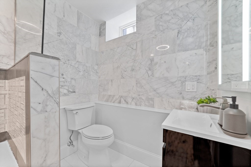 615 East 3rd Street, Unit 1 Boston, MA 02127 - Photo 32 of 42 a bathroom with a sink a toilet and shower
