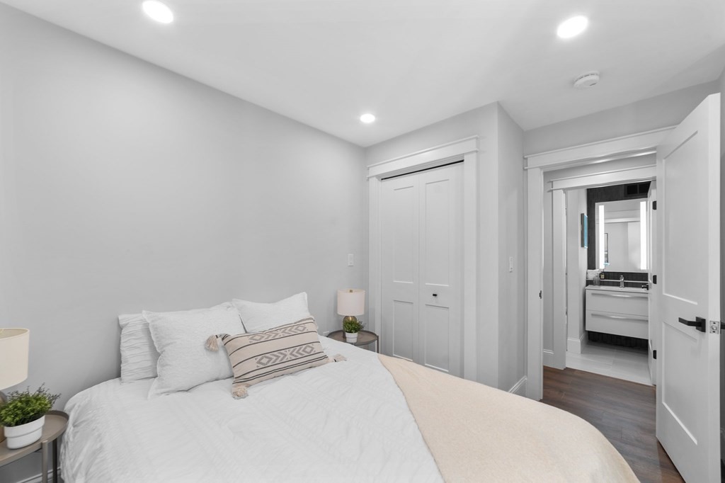615 East 3rd Street, Unit 1 Boston, MA 02127 - Photo 36 of 42 a bedroom with a bed and view of living room