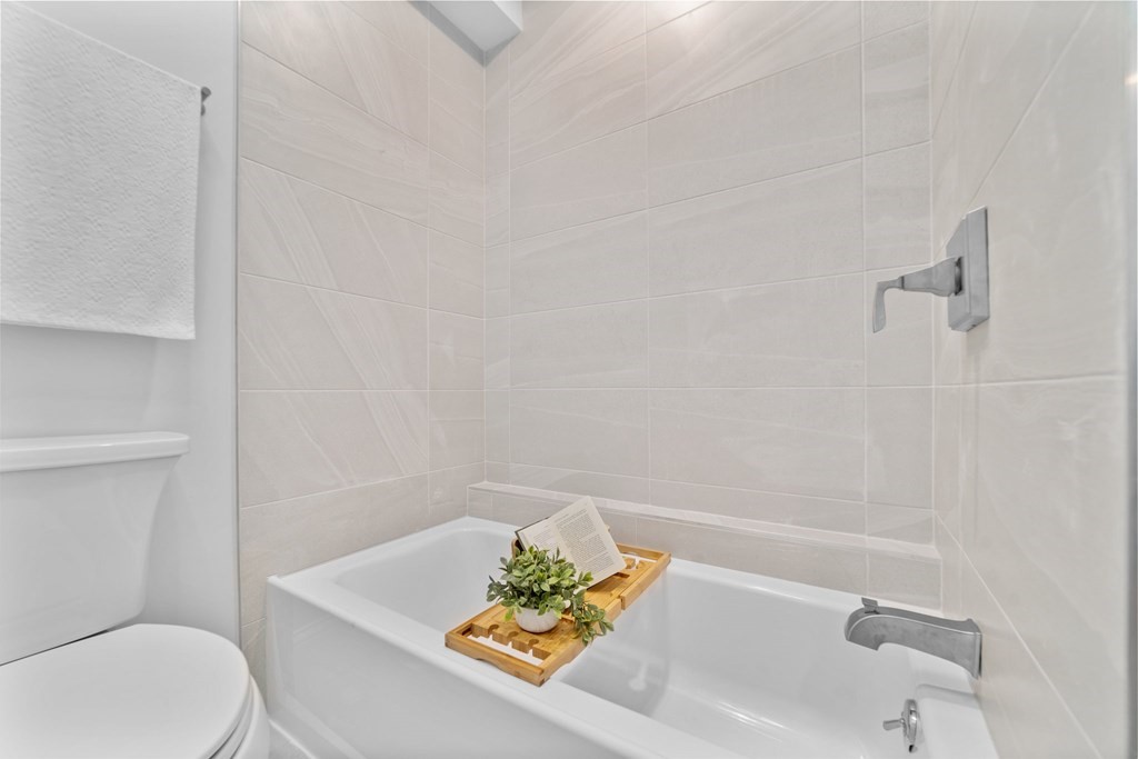 615 East 3rd Street, Unit 1 Boston, MA 02127 - Photo 39 of 42 a bath tub sitting next to a white toilet and a sink