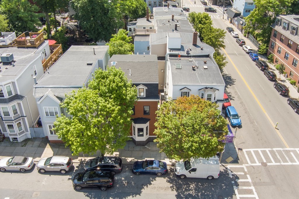 615 East 3rd Street, Unit 1 Boston, MA 02127 - Photo 6 of 42 an aerial view of a house with a yard and a parking space