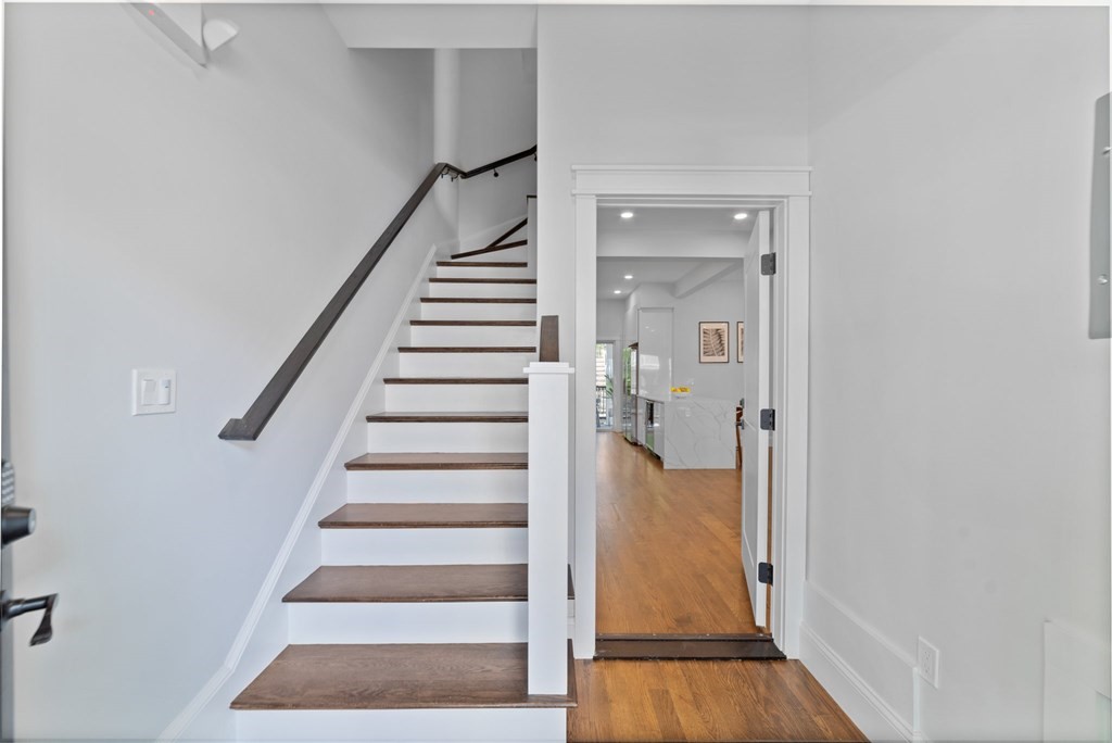 615 East 3rd Street, Unit 1 Boston, MA 02127 - Photo 7 of 42 a view of an entryway with wooden floor and staircase