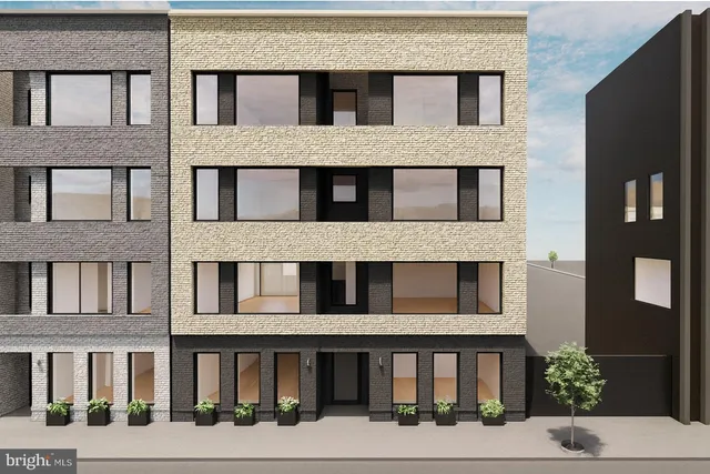 a front view of a building with a garden