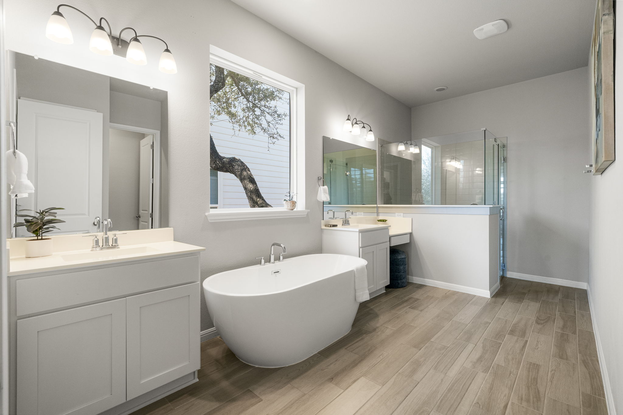 546 Hazy Hills Loop Dripping Springs, TX 78620 - Photo 8 of 40 The spa-like primary bathroom features a soaking tub, separate shower, walk-in shower, wak-in closet, and dual vanities for comfort and functionality.