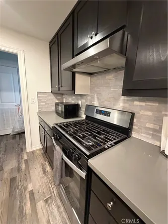 a stove top oven sitting inside of a kitchen