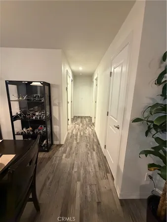 a view of a hallway with wooden floor