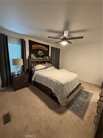a bedroom with a bed window and a ceiling fan