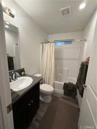 a bathroom with a double vanity sink toilet and shower