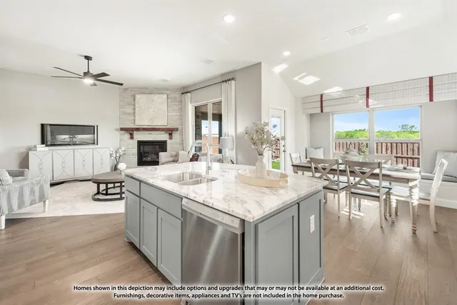 a kitchen with a sink a stove a oven a dining table and chairs