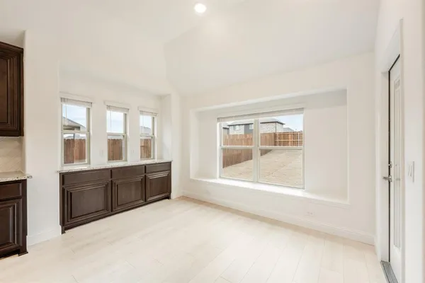 a large white room with windows and chandelier