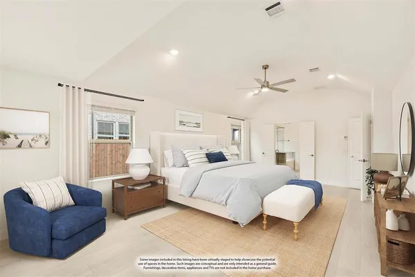 a spacious bedroom with a bed couch and window