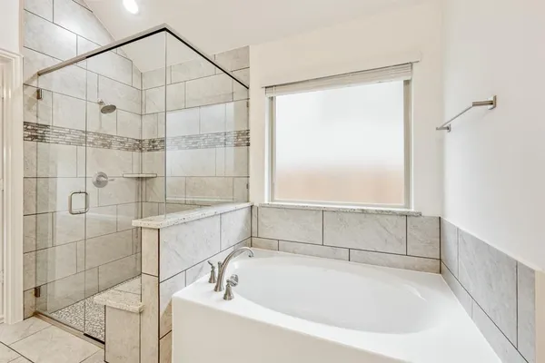 a bathroom with a bathtub and a shower