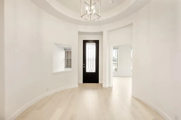 a view of a room with wooden floor