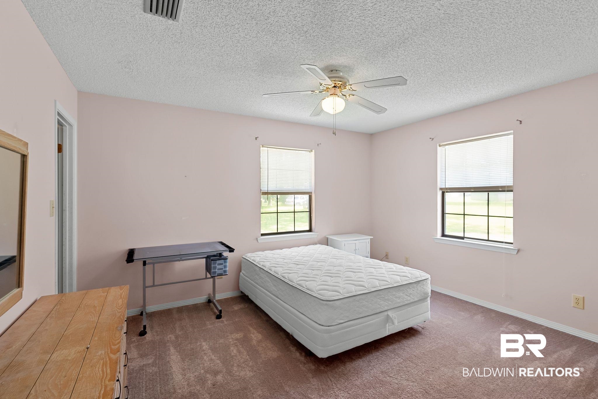 20540 Lacey Road Silverhill, AL 36576 - Photo 13 of 40 Spacious room featuring two windows with blinds, a ceiling fan with integrated lighting, textured ceilings, and carpet flooring
