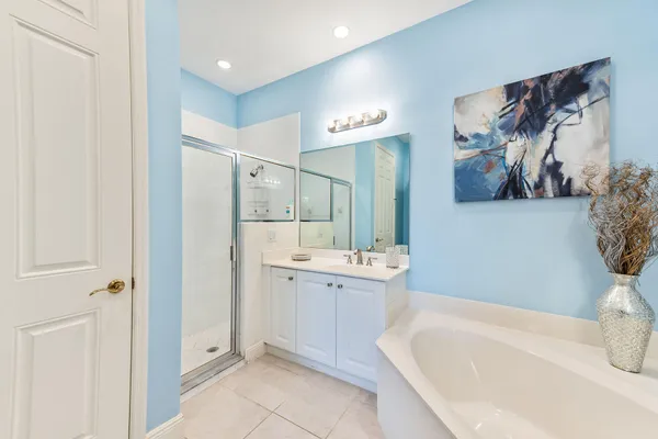 a bathroom with a bathtub sink and mirror