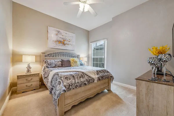 a bedroom with a bed and a chandelier