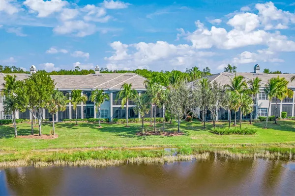 a view of a swimming pool with a big yard and large trees