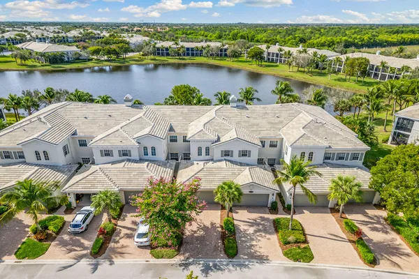 an aerial view of a house with a garden and lake view