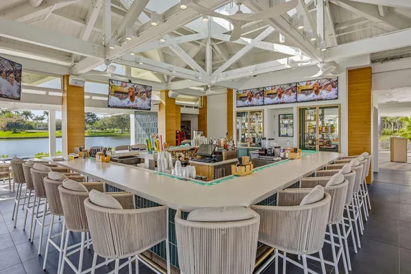 a view of a dining room with furniture large windows and wooden floor