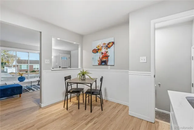 a view of a dining room with furniture and wooden floor