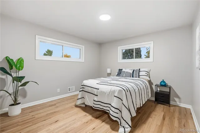 a bedroom with a bed and a potted plant