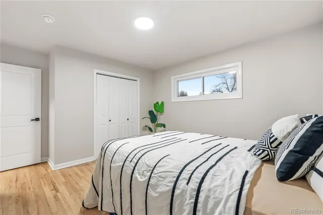 a bedroom with a bed and a painting on the wall