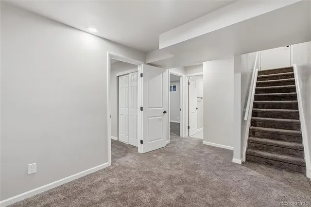 an empty room with a cabinet and mirrors