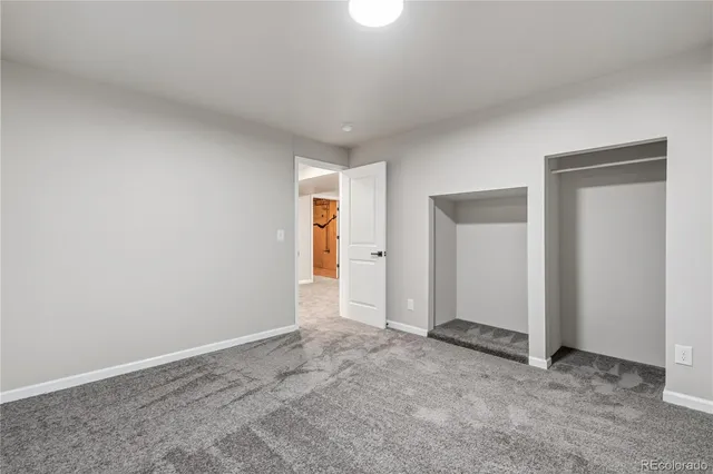 a bathroom with a toilet a sink a mirror and vanity