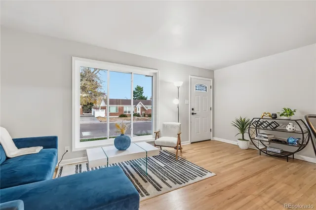 a living room with furniture rug and wooden floor