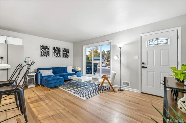 a living room with furniture rug and wooden floor